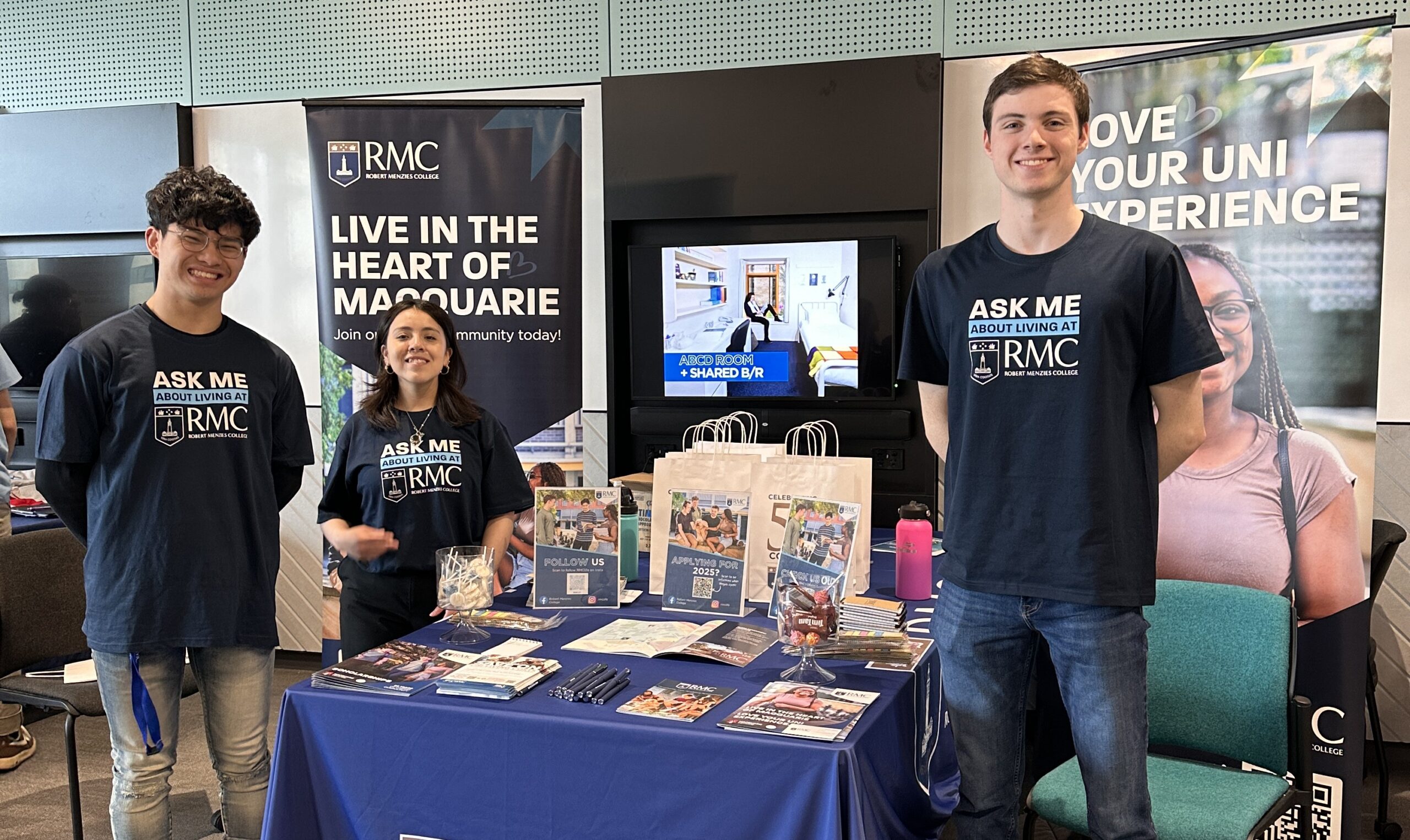 Robert Menzies College student ambassadors at a promotional stand at Macquarie University Open Day