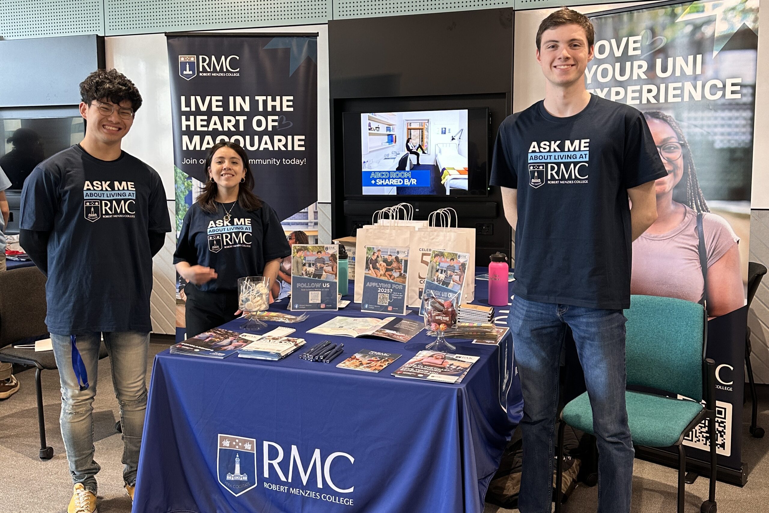 Robert Menzies College student ambassadors at a promotional stand at Macquarie University Open Day